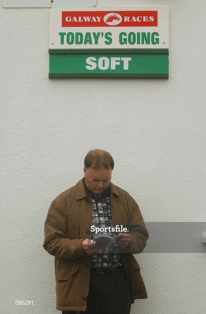 29 July 2002 A Racegoer studies the form before the G.P.T Galway Q.R Handicap, Galway Races, Ballybrit, Co. Galway, horse racing. Picture credit; Damien Eagers / SPORTSFILE *EDI*