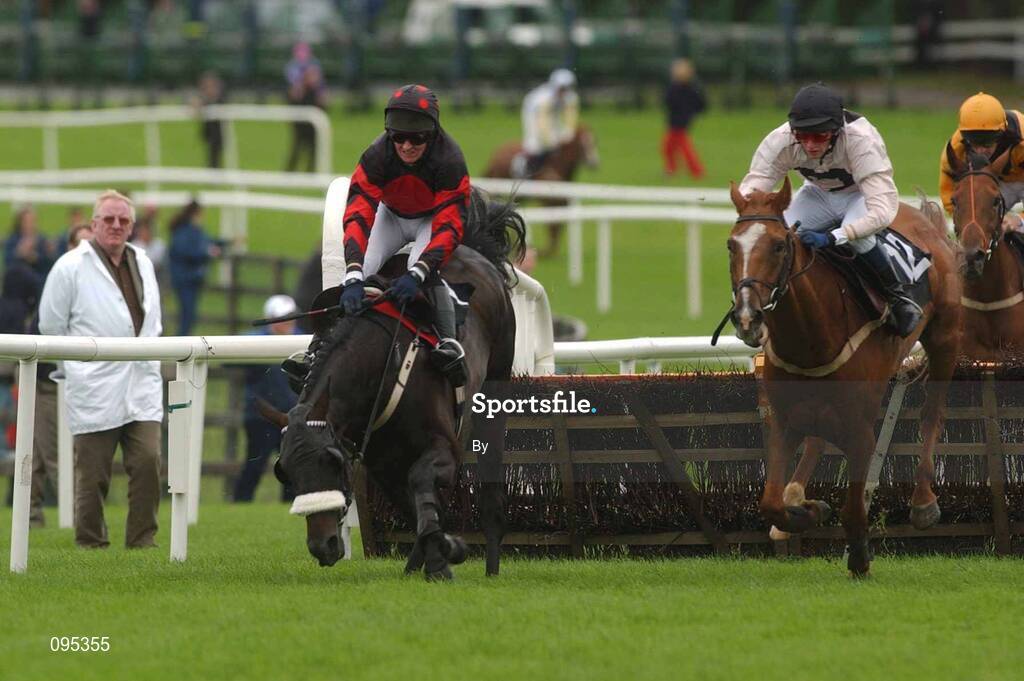 31 July 2002; Hip Pocket, left, with jockey Barry Geraghty fall as Teknash with Niall Madden Jnr. runs on to win the HP Software Acquisition Handicap Hurdle, Galway Races, Ballybrit, Co. Galway. Horse Racing. Picture credit; Damien Eagers / SPORTSFILE *EDI*