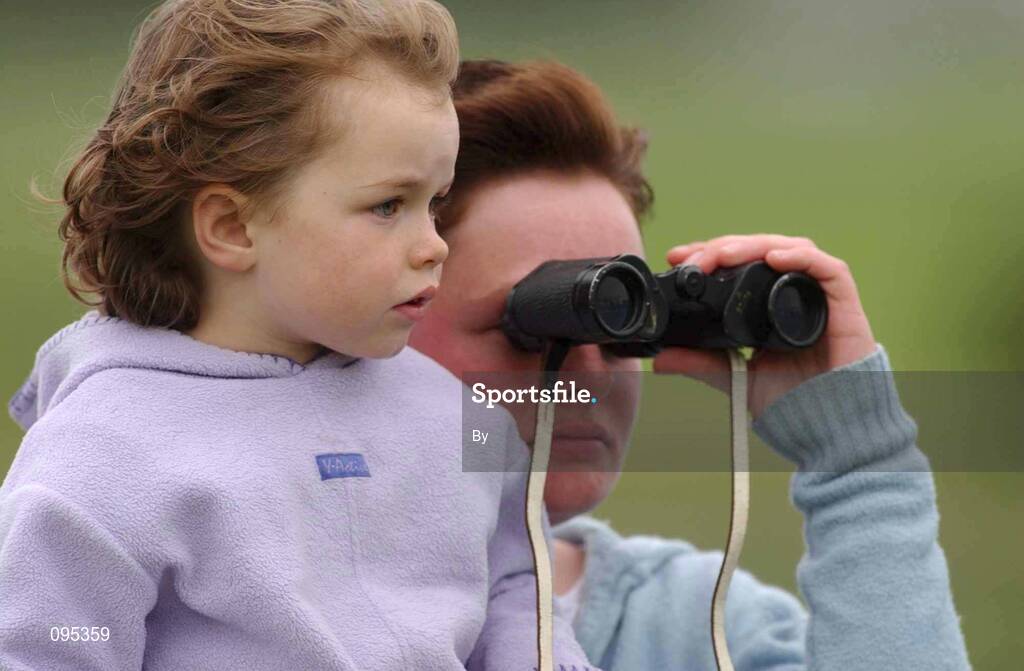 31 July 2002; Kaylen Folan, from Newcastle, Co. Galway, pictured with her mother Maura, keeps a close watch on the racing. Galway Races, Ballybrit, Co. Galway. Horse Racing. Picture credit; Damien Eagers / SPORTSFILE *EDI*