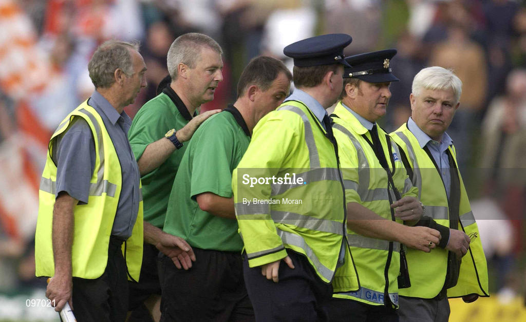 18 August 2002; Referee Seamus McCormack, third from left, is escorted off the field after the Bank of Ireland All-Ireland Senior Football Championship Quarter-Final Replay match between Armagh and Sligo at Páirc Tailteann in Navan, Meath. Photo by Brendan Moran/Sportsfile
