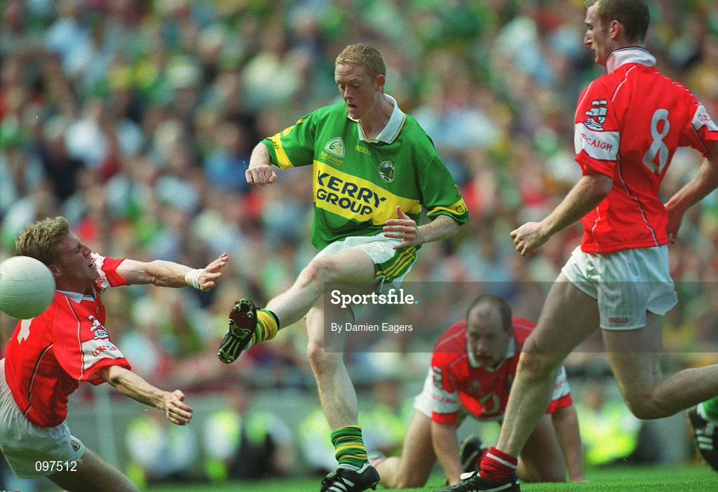 25 August 2002; Colm Cooper of Kerry shoots past Anthony Lynch of Cork, 4, to score his side's second goal during the Bank of Ireland All-Ireland Senior Football Championship Semi-Final match between Kerry and Cork at Croke Park in Dublin. Photo by Damien Eagers/Sportsfile