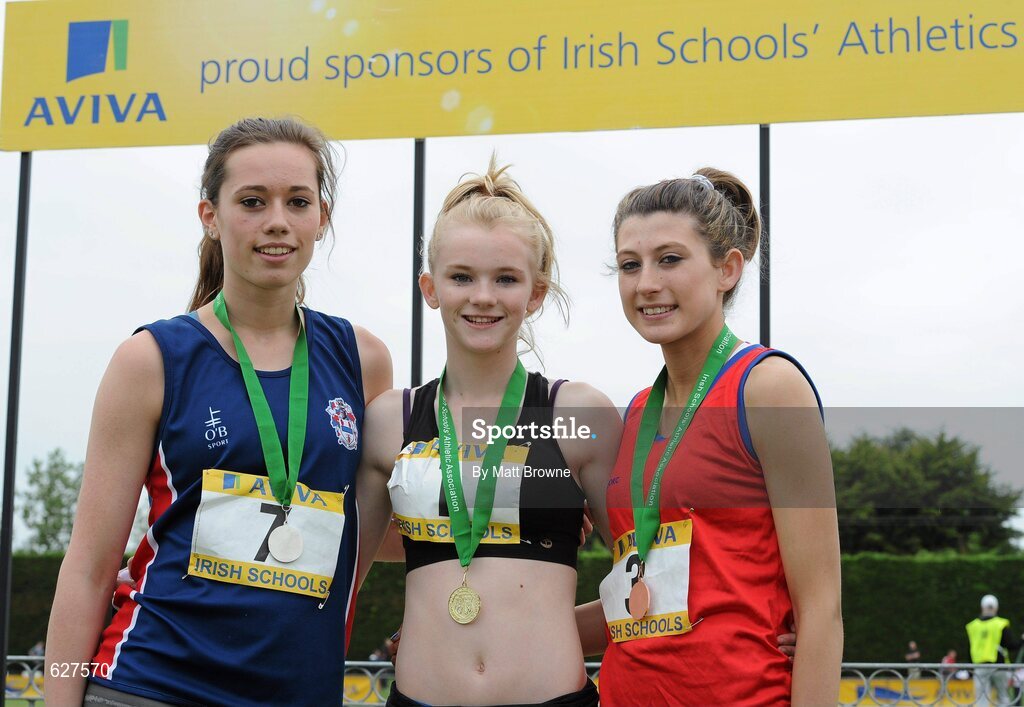 2 June 2012; Gold medal winner Laura Ann Costello, centre, from Dunmore CS, Co. Galway, with second place Roseanna McGuckian, Ballymena Academy, Co. Antrim, left, and third place Rachel Doyle, right, from, St Leo's College, Carlow, after the Junior Girls 100m at the Aviva All Ireland Schools’ Track and Field Championships 2012. Tullamore Harriers AC, Tullamore, Co. Offaly. Picture credit: Matt Browne / SPORTSFILE