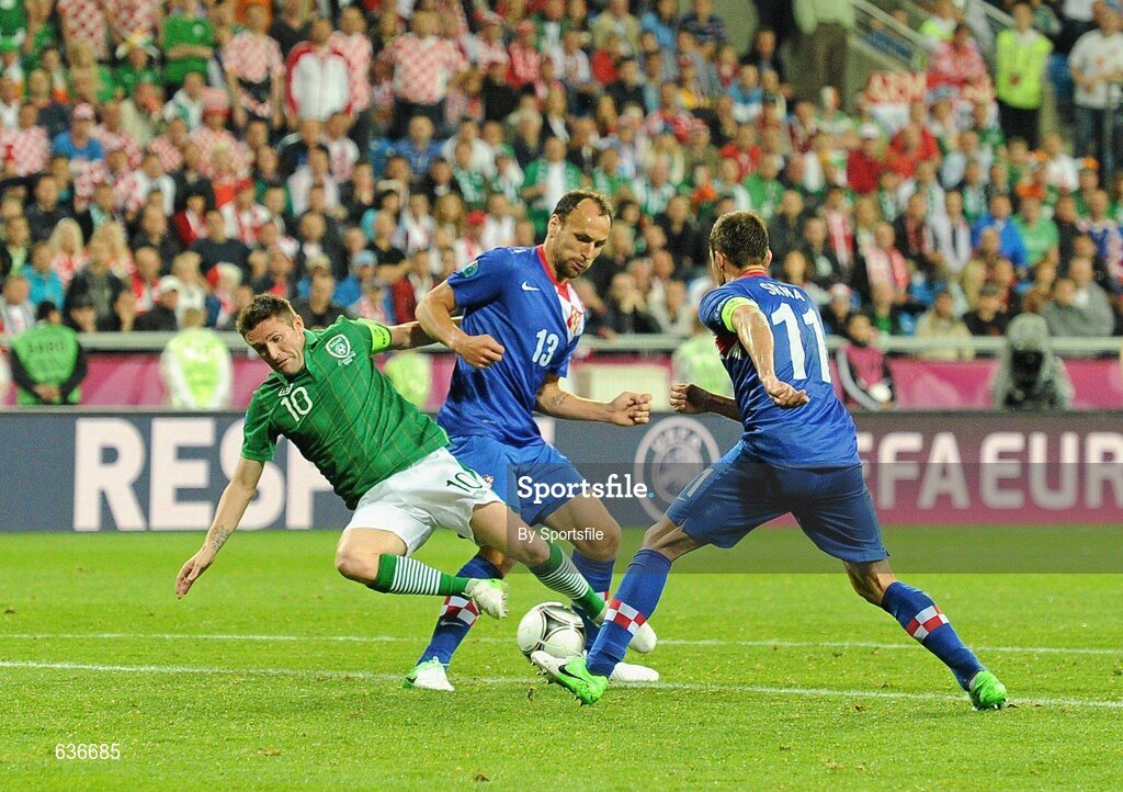 10 June 2012; Republic of Ireland's Robbie Keane is tackled on the edge of the box by Croatia's Gordon Schildenfeld,13, and Darijo Srna. EURO2012, Group C, Republic of Ireland v Croatia, Municipal Stadium Poznan, Poznan, Poland. Photo by Sportsfile