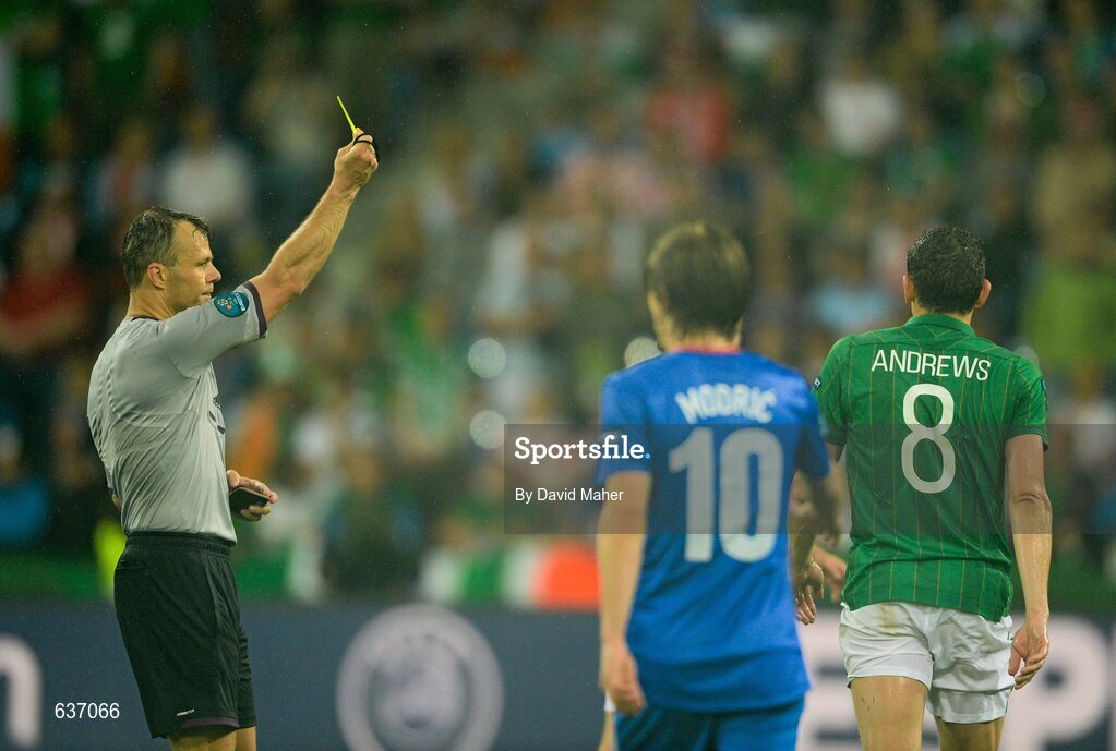 10 June 2012; Referee Bjorn Kuipers shows the yellow card to Keith Andrews, Republic of Ireland. EURO2012, Group C, Republic of Ireland v Croatia, Municipal Stadium Poznan, Poznan, Poland. Picture credit: David Maher / SPORTSFILE