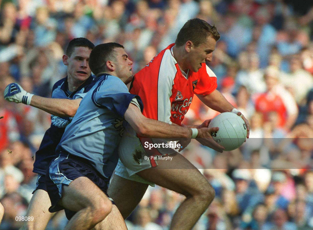 1 September 2002; Paddy McKeever of Armagh goes past the tackle of Paul Casey, centre, and Dublin goalkeeper Stephen Cluxton, to score a goal during the Bank of Ireland All-Ireland Senior Football Championship Semi-Final match between Armagh and Dublin at Croke Park in Dublin. Photo by Pat Murphy/Sportsfile