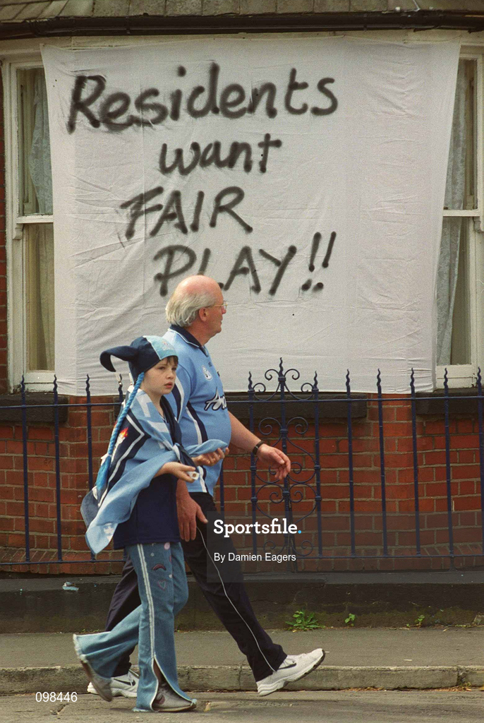 1 September 2002; Dublin supporters walk past a protest sign, in a residential area surrounding Croke Park, aimed at the GAA, on their way to the Bank of Ireland All-Ireland Senior Football Championship Semi-Final match between Armagh and Dublin at Croke Park in Dublin. Photo by Damien Eagers/Sportsfile