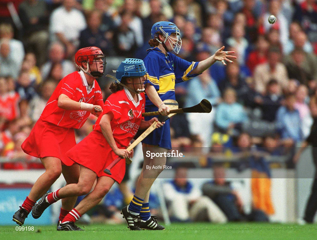 15 September 2002; Deirdre Hughes of Tipperary in action against Mary O'Connor, left, and Vivienne Harris of Cork during the All-Ireland Senior Camogie Championship Final match between Cork and Tipperary at Croke Park in Dublin. Photo by Aoife Rice/Sportsfile