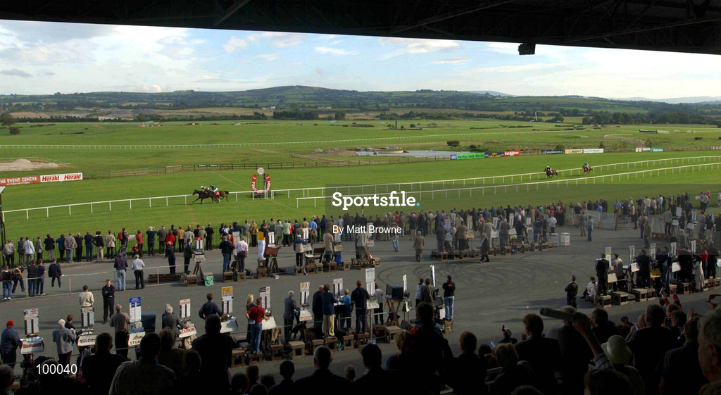 29 September 2002; The crowd watch on as Patriot Games, with Charlie Swan up, win the Panoramic Restaurant Rated  Hurdle from Patsy Veale, with Ruby Walsh up, at Punchestown Racecourse in Naas, Kildare. Photo by Matt Browne/Sportsfile