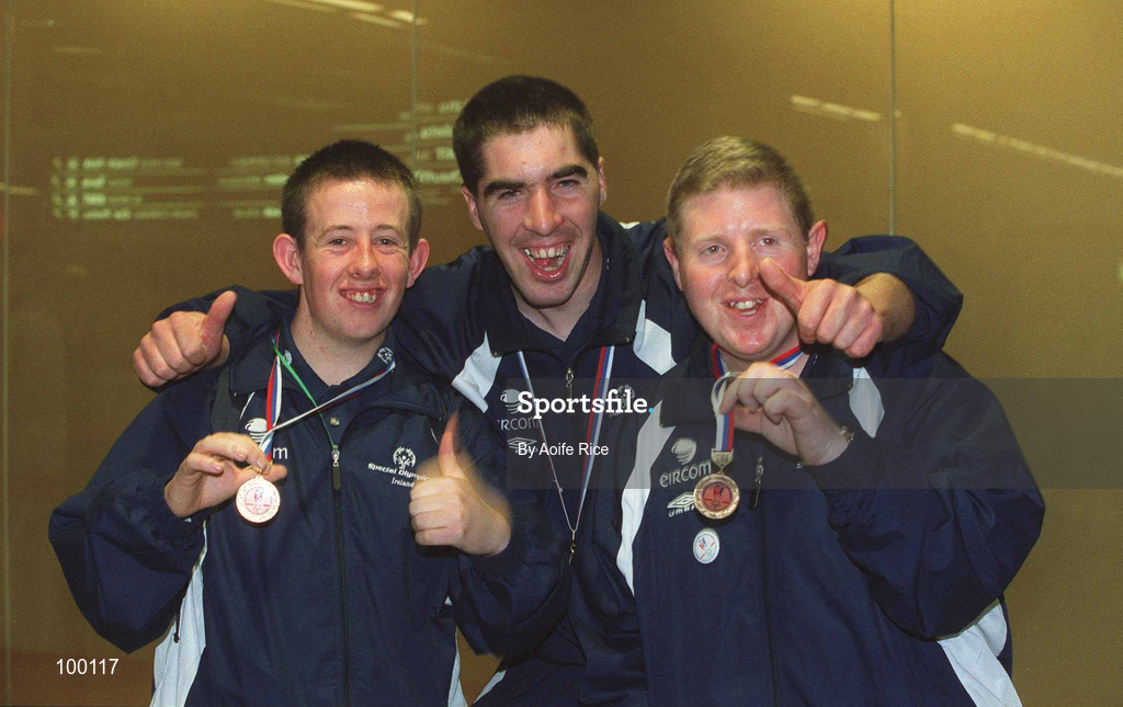 30 September 2002; Ireland's Special Olympics Basketball players, from left, Andrew Connolly, Michael Larkin and James O'Leary, from Wexford, who competed at the European Basketball Tournament in Moscow, pictured with their medals, on their arrival home at Dublin Airport in Dublin. Photo by Aoife Rice/Sportsfile