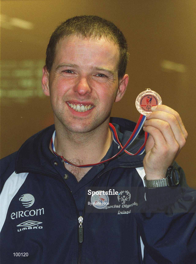 30 September 2002; Ireland's Special Olympics Basketball player Noel Murphy, from Wexford, who competed at the European Basketball Tournament in Moscow, pictured with his medal, on his arrival home at Dublin Airport in Dublin. Photo by Aoife Rice/Sportsfile