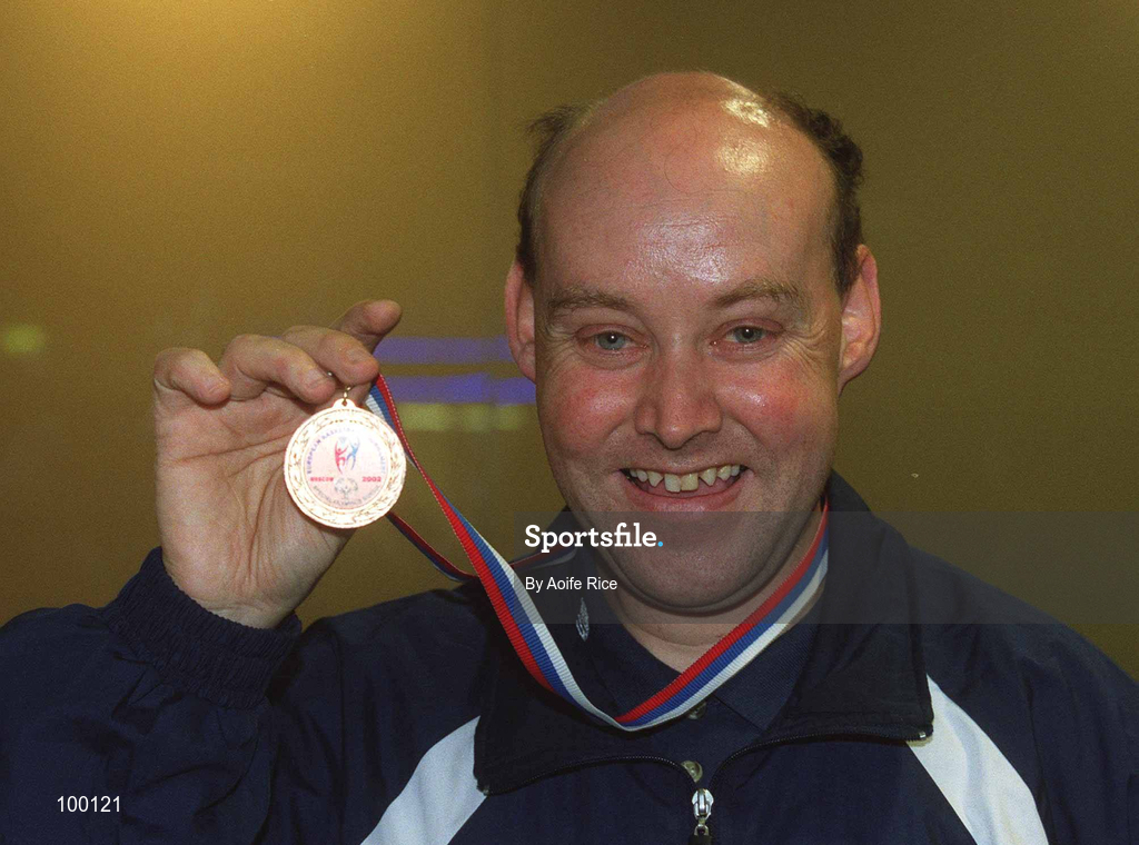 30 September 2002; Ireland's Special Olympics Basketball Captain, Fintan Broaders, from Wexford, who competed at the European Basketball Tournament in Moscow, pictured with his medal, on their arrival home at Dublin Airport in Dublin. Photo by Aoife Rice/Sportsfile
