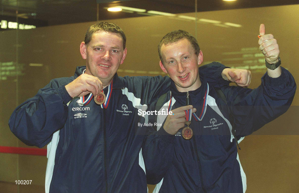 30 September 2002; Ireland's Special Olympics Basketball players Michael Cummins from Borris, Co. Carlow, left and team-mate Robert Jordan from Shillealagh, Co. Wicklow, who competed at the European Basketball Tournament in Moscow, pictured with their medals, on their arrival home at Dublin Airport in Dublin. Photo by Aoife Rice/Sportsfile