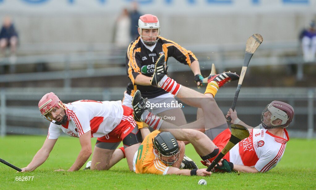 8 July 2012; Michael Herron, Antrim, supported by team-mate Damian Quinn, 1, collides with Kevin Hinphey, left, and Oisin McCloskey, right, Derry. Ulster GAA Hurling Senior Championship Final, Antrim v Derry, Casement Park, Belfast, Co. Antrim. Picture credit: Barry Cregg / SPORTSFILE