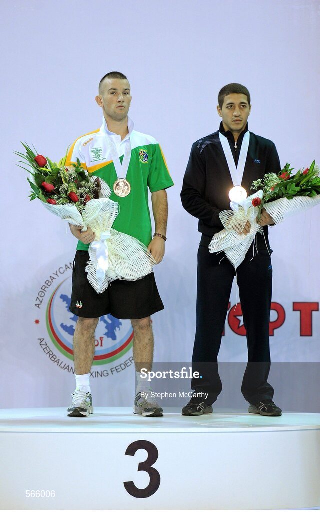 8 October 2011; John Joe Nevin, Cavan B.C., representing Ireland, after being presented with his 2011 AIBA World Boxing Championships 56kg bronze medal alongside fellow bronze medalist Anvar Yunusov, Tajikistan. 2011 AIBA World Boxing Championships. Heydar Aliyev Sports and Exhibition Complex, Baku, Azerbaijan. Picture credit: Stephen McCarthy / SPORTSFILE