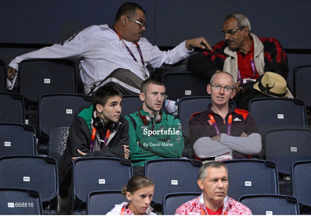 29 July 2012; Team Ireland boxers Michael Conlon, left, and Paddy Barnes, centre, look on from the stands ahead of Adam Nolan's welter 69kg round of 32 contest bout against Carlos Sanchez Estacio, Ecuador. London 2012 Olympic Games, Boxing, South Arena 2, ExCeL Arena, Royal Victoria Dock, London, England. Picture credit: David Maher / SPORTSFILE