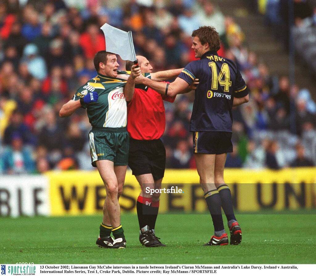 13 October 2002; Linesman Gay McCabe intervenes in a tussle between Ireland's Ciaran McManus and Australia's Luke Darcy. Ireland v Australia, International Rules Series, Test 1, Croke Park, Dublin. Picture credit; Ray McManus / SPORTSFILE