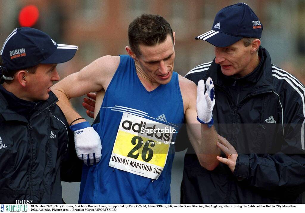28 October 2002; Gary Crossan, first Irish Runner home, is supported by Race Official, Liam O'Riain, left, and the Race Director, Jim Aughney, after crossing the finish. adidas Dublin City Marathon 2002. Athletics. Picture credit; Brendan Moran / SPORTSFILE