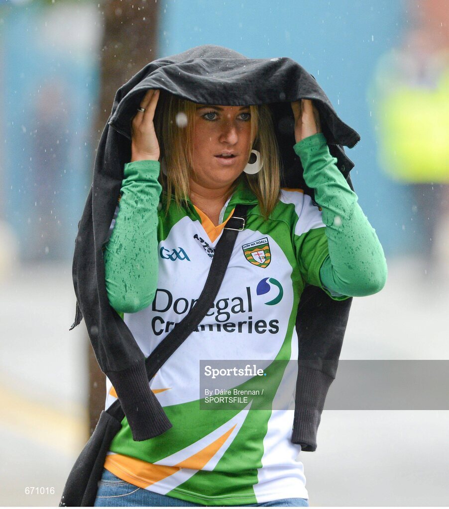 5 August 2012; Donegal supporter Stephanie Devlin, from Ballybofey, Co. Donegal, shelters from the rain on her way to the game. GAA Football All-Ireland Senior Championship Quarter-Final, Donegal v Kerry, Croke Park, Dublin. Picture credit: Dáire Brennan / SPORTSFILE