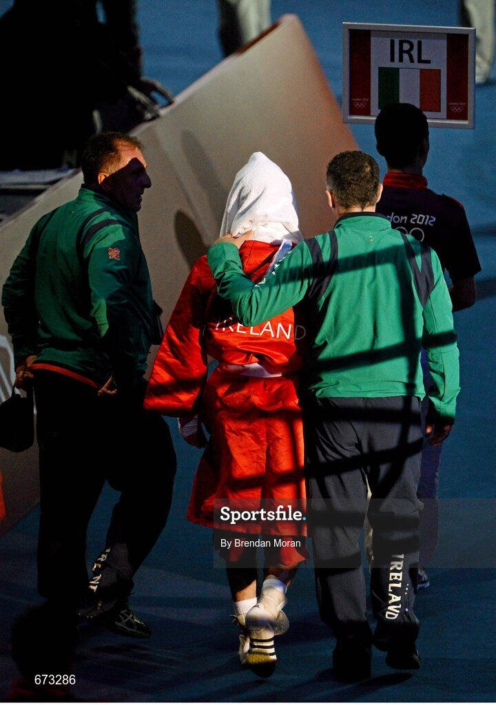 11 August 2012; John Joe Nevin, Ireland, makes his way from the ring accompanied by Team Ireland boxing head coach Billy Walsh, right, and Team Ireland boxing technical & tactical head coach Zaur Anita after his men's bantam 56kg final contest. London 2012 Olympic Games, Boxing, South Arena 2, ExCeL Arena, Royal Victoria Dock, London, England. Picture credit: Brendan Moran / SPORTSFILE