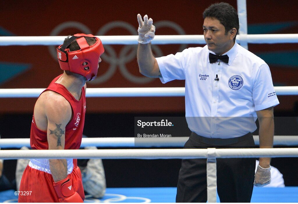 11 August 2012; John Joe Nevin, Ireland, receives a count from the referee during the third round of his men's bantam 56kg final contest. London 2012 Olympic Games, Boxing, South Arena 2, ExCeL Arena, Royal Victoria Dock, London, England. Picture credit: Brendan Moran / SPORTSFILE