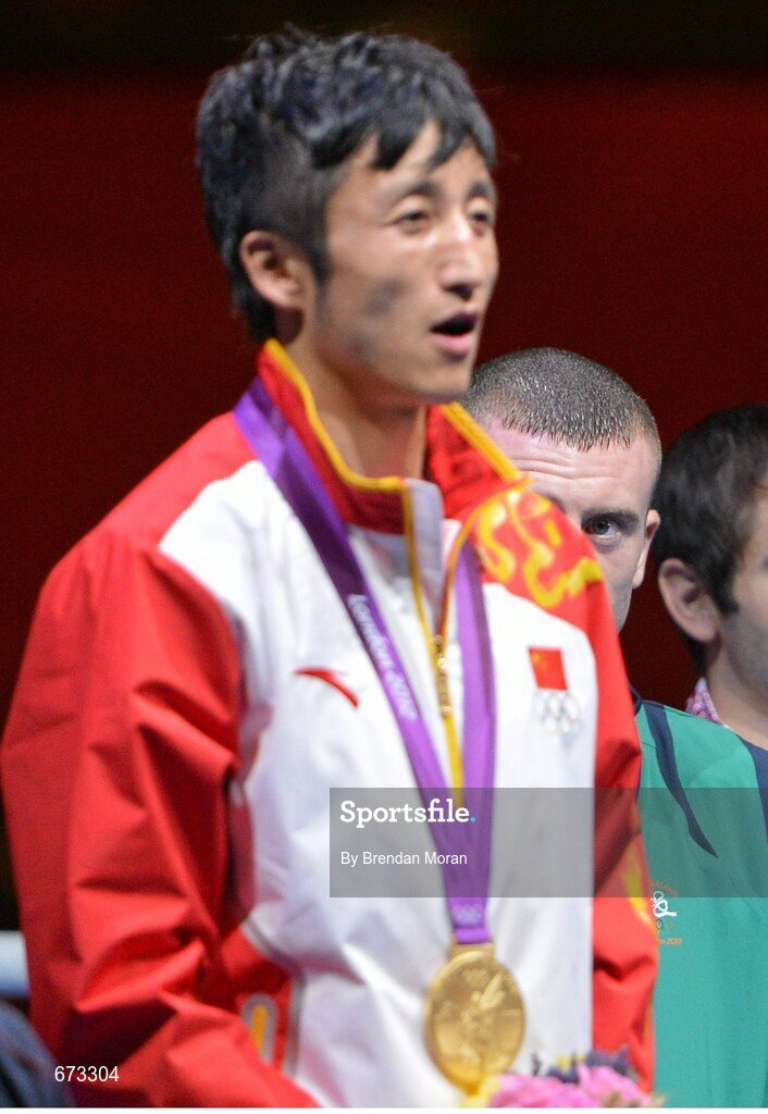 11 August 2012; Team Ireland's Paddy Barnes, men's light fly 49kg, looks up at Shiming Zou of China during their medal presentation. London 2012 Olympic Games, Boxing, South Arena 2, ExCeL Arena, Royal Victoria Dock, London, England. Picture credit: Brendan Moran / SPORTSFILE