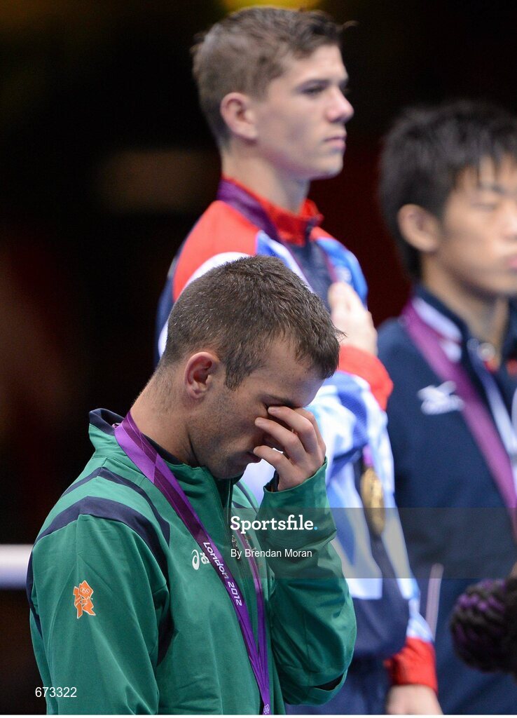 11 August 2012; Team Ireland's John Joe Nevin, men's bantam 56kg, looks disappointed during the playing of the gold medallists National Anthem. London 2012 Olympic Games, Boxing, South Arena 2, ExCeL Arena, Royal Victoria Dock, London, England. Picture credit: Brendan Moran / SPORTSFILE