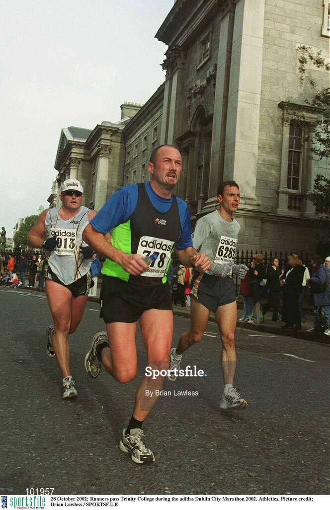 28 October 2002; Runners pass Trinity College during the adidas Dublin City Marathon 2002. Athletics. Picture credit; Brian Lawless / SPORTSFILE