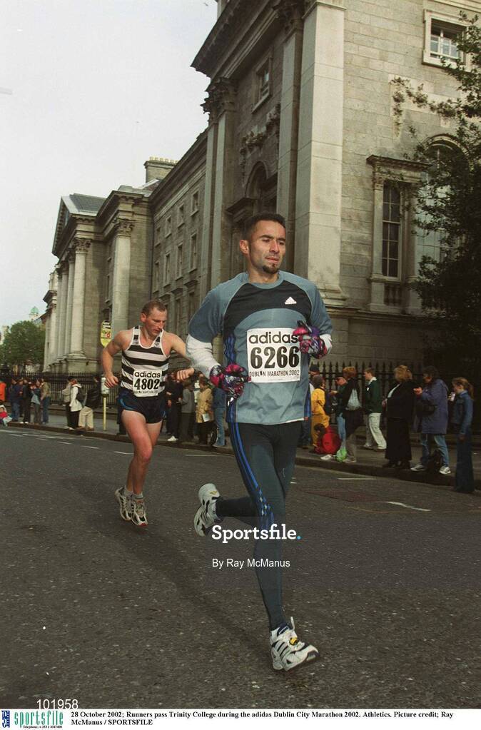 28 October 2002; Runners pass Trinity College during the adidas Dublin City Marathon 2002. Athletics. Picture credit; Ray McManus / SPORTSFILE