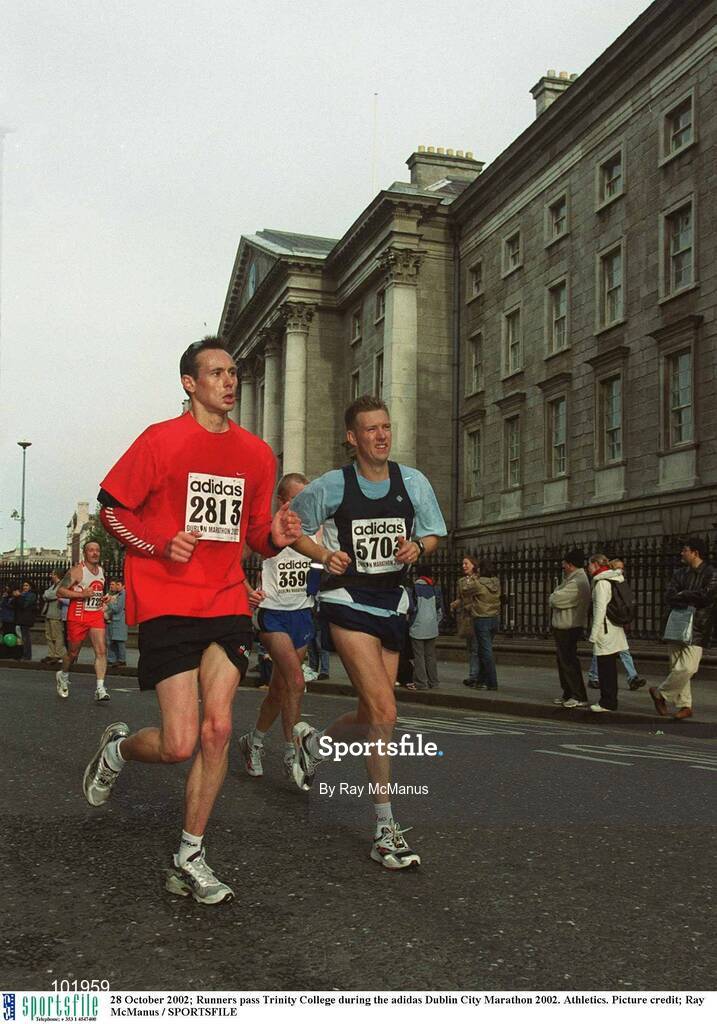 28 October 2002; Runners pass Trinity College during the adidas Dublin City Marathon 2002. Athletics. Picture credit; Ray McManus / SPORTSFILE