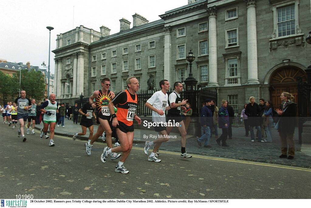 28 October 2002; Runners pass Trinity College during the adidas Dublin City Marathon 2002. Athletics. Picture credit; Ray McManus / SPORTSFILE