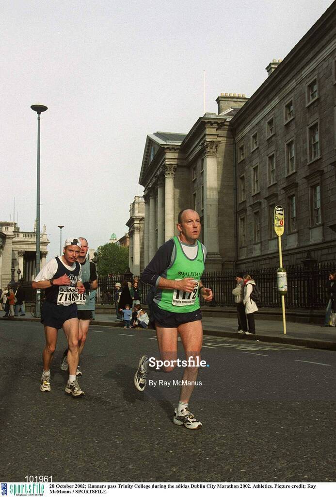 28 October 2002; Runners pass Trinity College during the adidas Dublin City Marathon 2002. Athletics. Picture credit; Ray McManus / SPORTSFILE