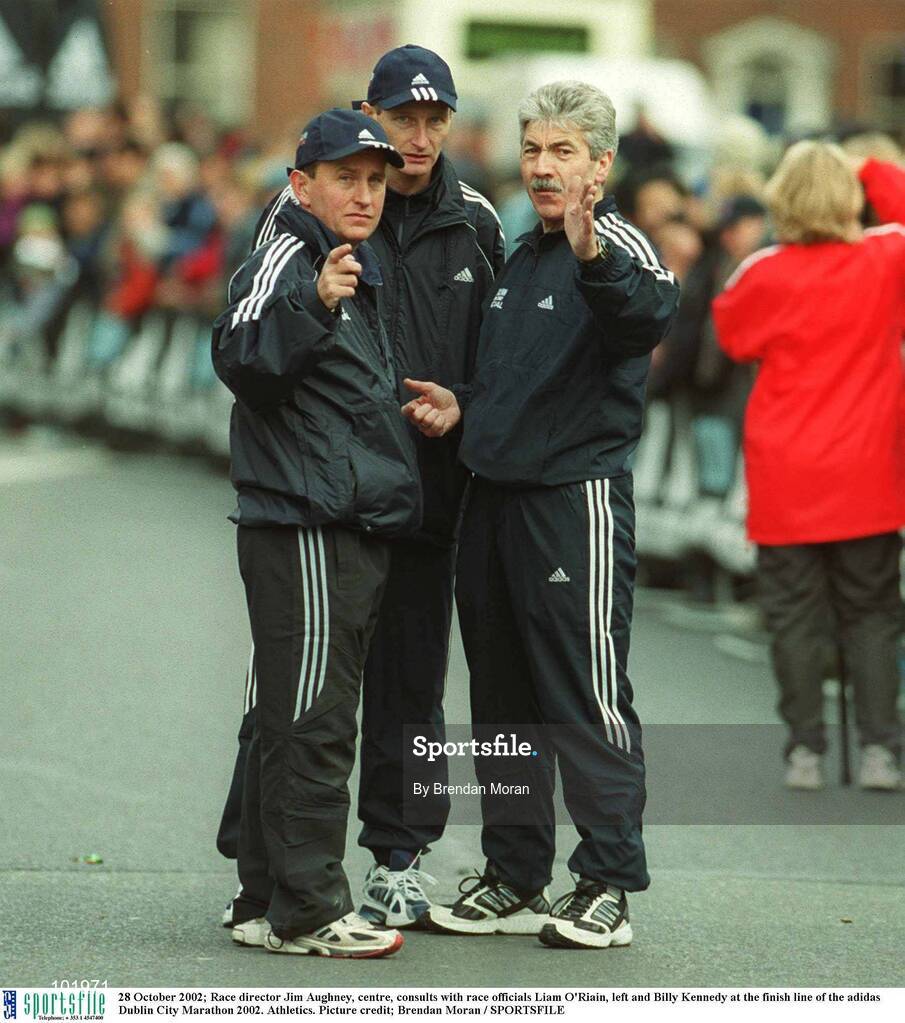 28 October 2002; Race director Jim Aughney, centre, consults with race officials Liam O'Riain, left and Billy Kennedy at the finish line of the adidas Dublin City Marathon 2002. Athletics. Picture credit; Brendan Moran / SPORTSFILE