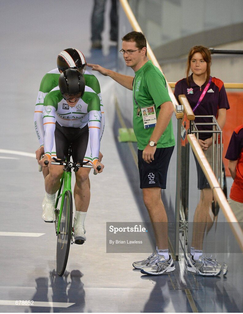 30 August 2012; Ireland's tandem pairing James Brown, from Stonehouse, England, behind, and pilot Damien Shaw, from Mullingar, Co. Westmeath, are greeted by coach Brian Nugent, from Cookstown, Dublin, after competeing in the qualifiying round of the men's individual B pursuit. The tandem pair finished in a time of 4:25.557 qualifying them for this afternoon's Bronze medal ride off. London 2012 Paralympic Games, Cycling, Velodrome, Olympic Park, Stratford, London, England. Picture credit: Brian Lawless / SPORTSFILE
