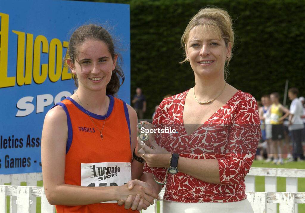 27th July 2002; Catriona McMahon, St Mary's AC, Rathkeale, Co. Limerick,  is presented with the Gold Medal by Rosemary Lyster, Marketing Manager, Lucozade Sport, after the U.18 3,000m Walk Final at the Lucozade Sport AAI Juvenile Track & Field Championship of Ireland 2002, Tullamore Harriers Stadium, Tullamore, Co. Offaly. Athletics. Picture credit; Ray McManus / SPORTSFILE *EDI*