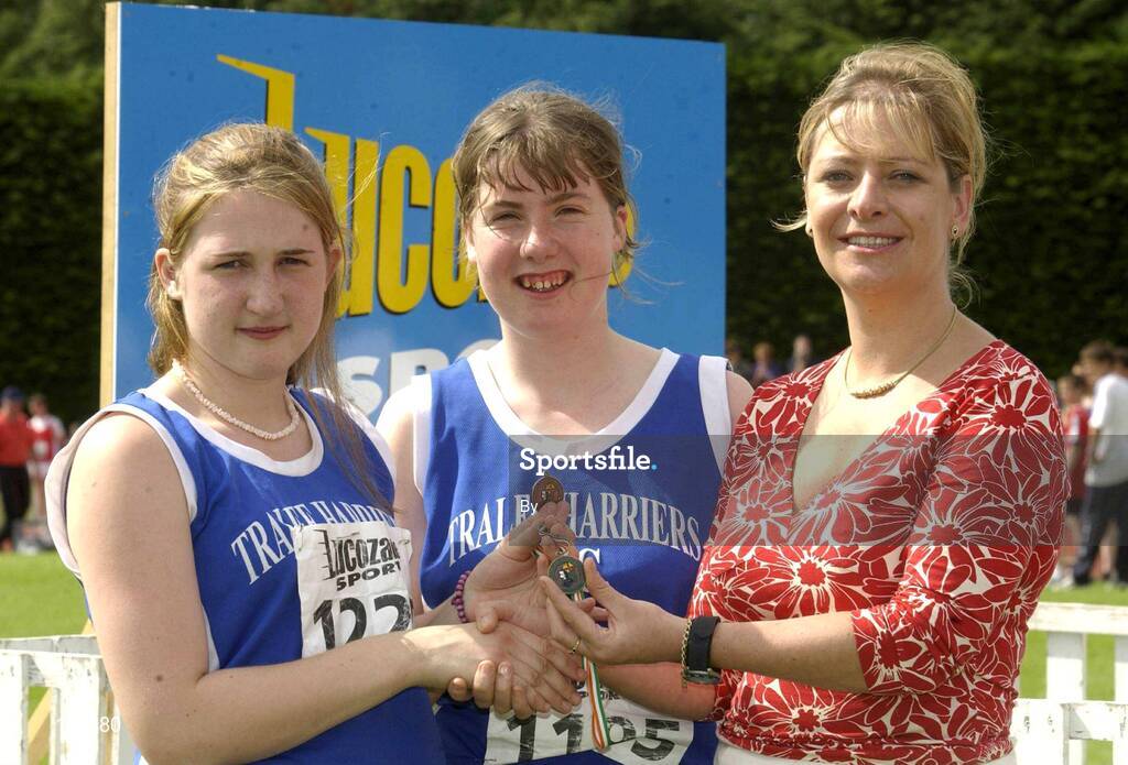 27th July 2002; Tralee AC clubmates Claire Wheeler, left and Emer Moriarty are  presented with the Bronze Medals by Rosemary Lyster, Marketing Manager, Lucozade Sport, after the U.18 and U.17  3,000m Walk Final at the Lucozade Sport AAI Juvenile Track & Field Championship of Ireland 2002, Tullamore Harriers Stadium, Tullamore, Co. Offaly. Athletics. Picture credit; Ray McManus / SPORTSFILE *EDI*