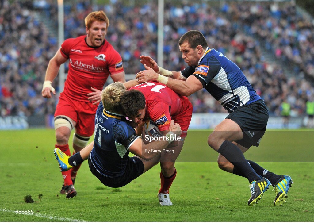 22 September 2012; Lee Jones, Edinburgh, is tackled by Fionn Carr, left, and Shane Jennings, Leinster. Celtic League 2012/13, Round 4, Leinster v Edinburgh, RDS, Ballsbridge, Dublin. Picture credit: Barry Cregg / SPORTSFILE