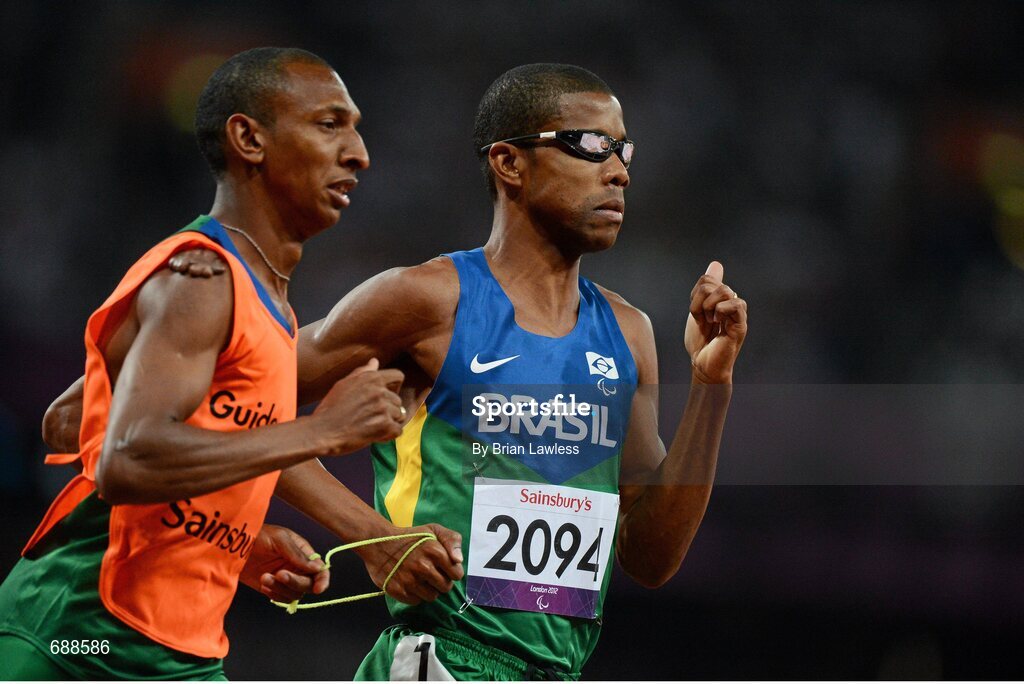3 September 2012; Odair Santos, Brazil, and his guide Carlos Antonio dos Santos, on their way to finishing 2nd in the Men's 1500m - T11. London 2012 Paralympic Games, Athletics, Olympic Stadium, Olympic Park, Stratford, London, England. Picture credit: Brian Lawless / SPORTSFILE
