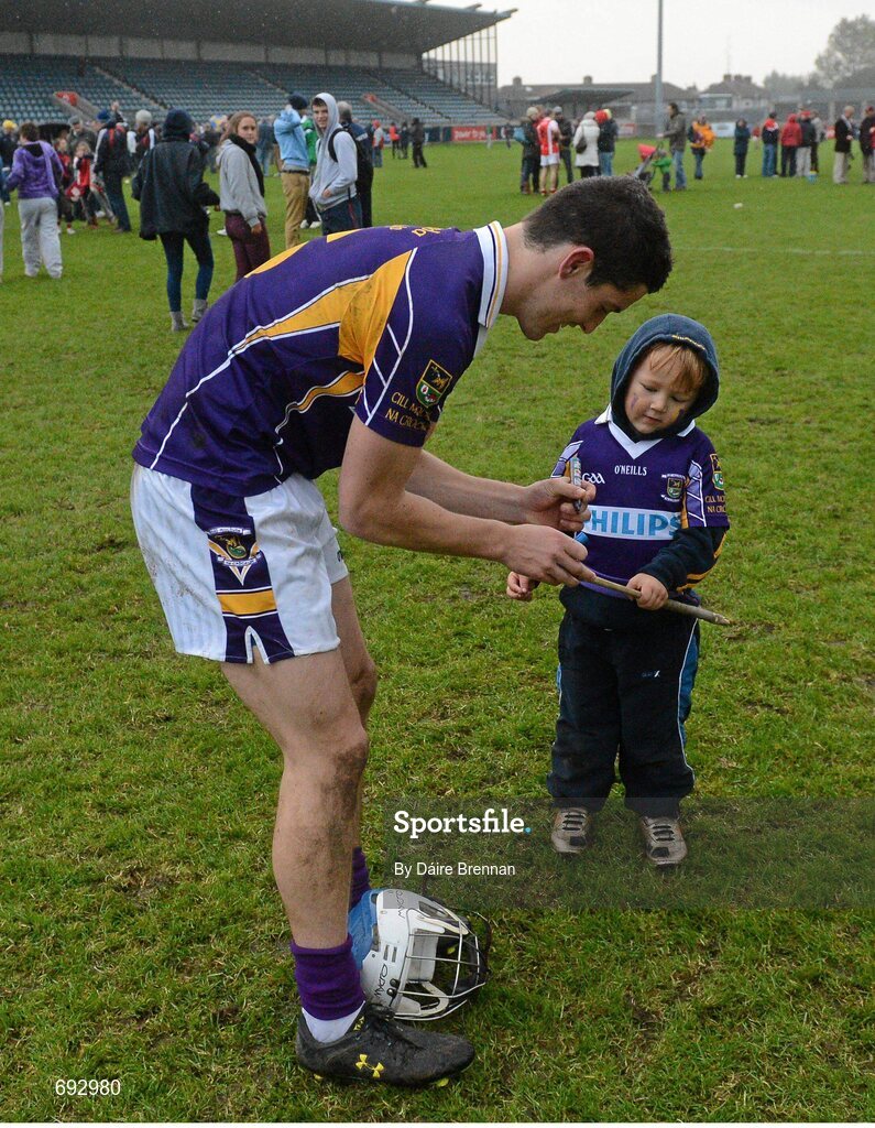 14 October 2012; Rory O'Carroll, Kilmacud Crokes, signs the hurl of four year old supporter Ryan Crowley, after the game. Dublin County Senior Hurling Championship Final, Cuala v Kilmacud Crokes, Parnell Park, Dublin. Picture credit: Dáire Brennan / SPORTSFILE