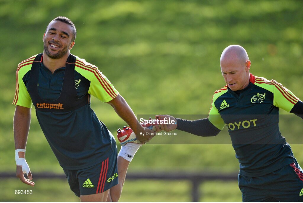 17 October 2012; Munster's Simon Zebo is given a 'helping hand' by team-mate Peter Stringer as they stretch during squad training ahead of their side's Heineken Cup, Pool 1, Round 2, game against Edinburgh on Sunday. Munster Rugby Squad Training, University of Limerick, Limerick. Picture credit: Diarmuid Greene / SPORTSFILE