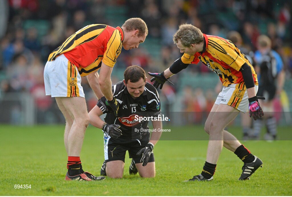 21 October 2012; Michael Quilligan, Newcastlewest, is helped to his feet at the end of the game by Garrett Noonan, left, and Eoin Barry, Dromcollogher Broadford. Limerick County Senior Football Championship Final, Dromcollogher Broadford v Newcastlewest, Gaelic Grounds, Limerick. Picture credit: Diarmuid Greene / SPORTSFILE