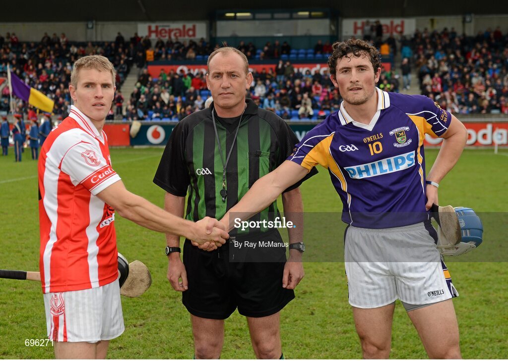 14 October 2012; Bobby Browne, Cuala, left, and Ross O'Carroll, Kilmacud Crokes, shake hands in front of referee Peadar Behan before the Dublin County Senior Hurling Championship Final match between Cuala and Kilmacud Crokes at Parnell Park in Dublin. Photo by Ray McManus/Sportsfile