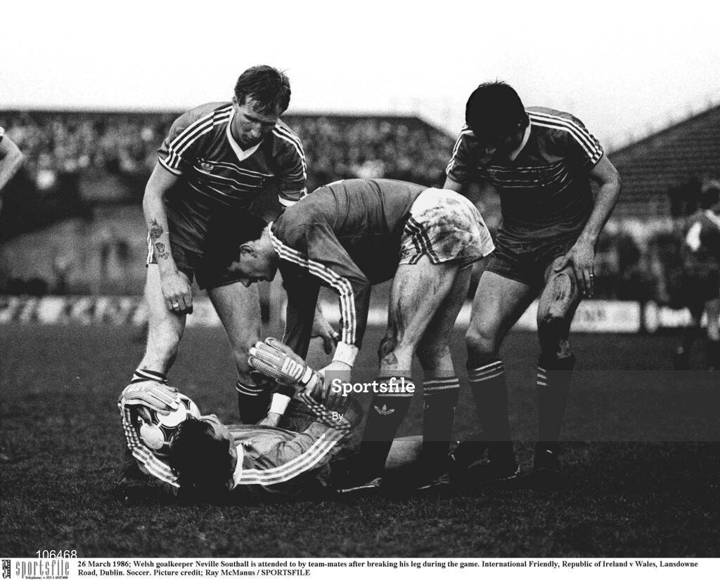 26 March 1986; Welsh goalkeeper Neville Southall is attended to by team-mates after breaking his leg during the game. International Friendly, Republic of Ireland v Wales, Lansdowne Road, Dublin. Soccer. Picture credit; Ray McManus / SPORTSFILE