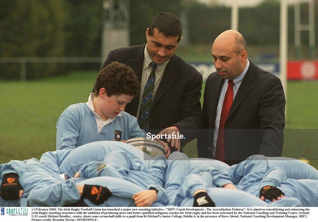 26 February 2003; The Irish Rugby Football Union has launched a major new coaching initiative - "IRFU Coach Development - The Accreditation Pathway". It is aimed at consolidating and enhancing the Irish Rugby coaching structures with the ambition of producing more and better qualified indignous coaches for Irish rugby and has been welcomed by the National Coaching and Training Centre. Ireland U-21 coach Michael Bradley , centre, shows some scrum-half skills to a pupil from St Michael's Junior College, Dublin 4, in the presence of Steve Aboud, National Coaching Development Manager, IRFU. Picture credit; Brendan Moran / SPORTSFILE .