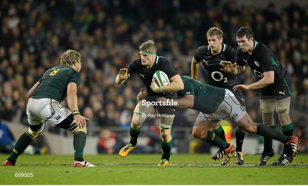 10 November 2012; Jamie Heaslip, Ireland, supported by his back-row team-mates Chris Henry and Peter O'Mahony, is tackled by CJ van der Linde, South Africa. Autumn International, Ireland v South Africa, Aviva Stadium, Lansdowne Road, Dublin. Picture credit: Ray McManus / SPORTSFILE