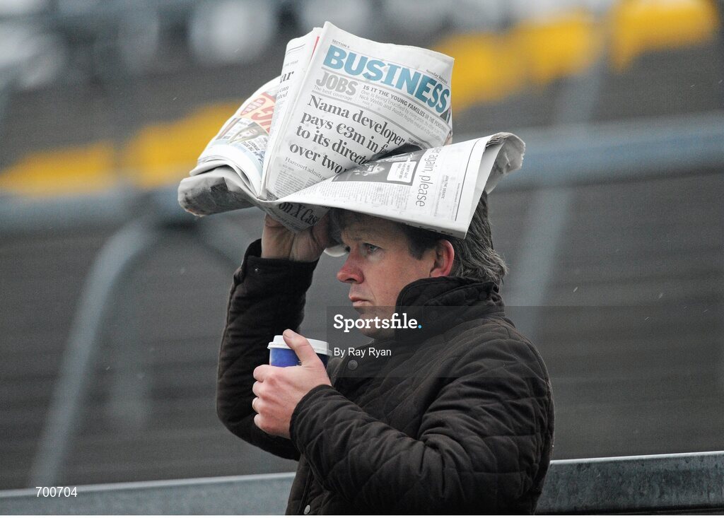 18 November 2012; A supporter covers himself from the rain. Galway County Senior Hurling Championship Final, Loughrea v St. Thomas, Pearse Stadium, Galway. Picture credit: Ray Ryan / SPORTSFILE