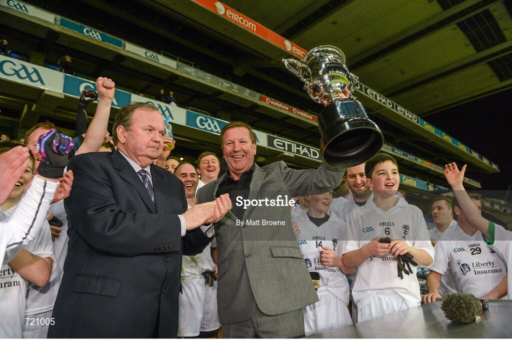 14 February 2013; Uachtarán Chumann Lúthchleas Gael Liam Ó Néill presents Kildare captain Ronnie Whelan with the cup after the Alan Kerins GAA Challenge, supported by Liberty Insurance, which took place in Croke Park on Valentine's Day. For more information visit alankerinsprojects.org. Croke Park, Dublin. Picture credit: Matt Browne / SPORTSFILE
