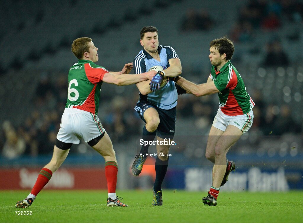 2 March 2013; Bernard Brogan, Dublin, is tackled by Mayo defenders Donal vaughan, left, and Ger Cafferkey. Allianz Football League, Division 1, Dublin v Mayo, Croke Park, Dublin. Picture credit: Ray McManus / SPORTSFILE