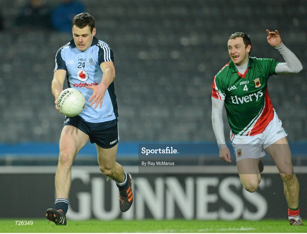 2 March 2013; Kevin McManamon shoots, past Mayo's Keith Higgins, to score the second Dublin goal. Allianz Football League, Division 1, Dublin v Mayo, Croke Park, Dublin. Picture credit: Ray McManus / SPORTSFILE