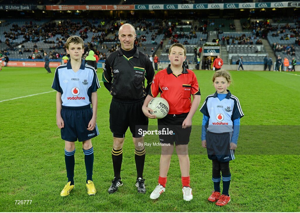 2 March 2013; Match referee Cormac Reilly with Mark Cleary, aged 12, left, from Raheny GAA, Jack Roche, aged 11, Trinity Gaels, and Caoimhe Keohane, aged nine, Scoil Uí Chonaill, before the game. Allianz Football League, Division 1, Dublin v Mayo, Croke Park, Dublin. Picture credit: Ray McManus / SPORTSFILE