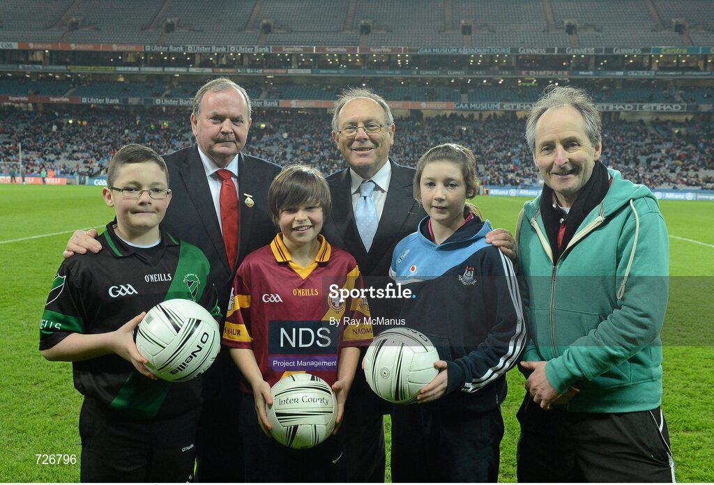 2 March 2013; Uachtarán Chumann Lúthchleas Gael Liam Ó Néill, in the company of Donal Bollard, Allianz Ireland, and Edward O'Riordan, Chairman of Cumann na mBunscoil, right, makes a presentation to exceptional players from the Allianz Cumann na mBunscoil finals. The recipients are, left to right, Nathan Burke, aged 12, Scoil Fhursa, Kilmore West, Neil Rock, aged 12, Rush National School and Ciara Holland, aged 12, St Helen's Portmarnock . Allianz Football League, Division 1, Dublin v Mayo, Croke Park, Dublin. Picture credit: Ray McManus / SPORTSFILE